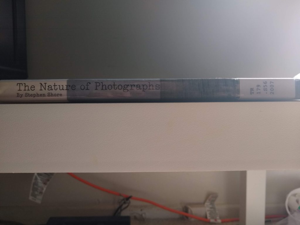 Image of the spine of the Nature of Photographs for a book review on Notes of Oak Literary Blog