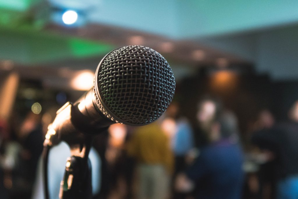 A photo of a microphone at a live poetry reading.