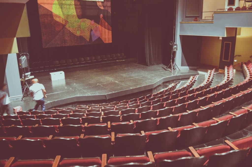 Photo of theater seating hosting a live poetry reading