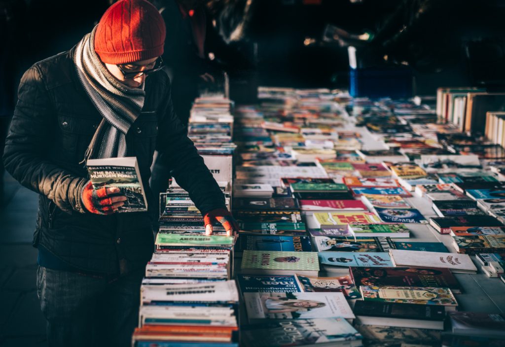 Photo of man looking through published literature