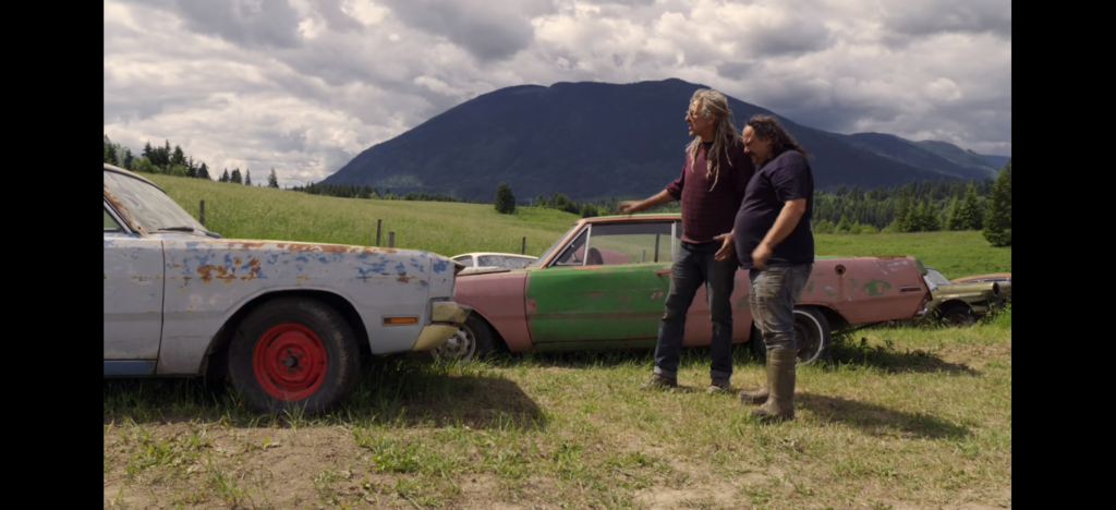 Screenshot of Mike Hall and Avery Shoaf looking at a Dodge Dart Swinger in Episode 1 of Rust Valley Restorers.