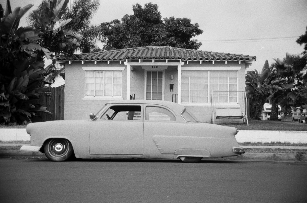 Photo of old car parked in front of house in Los Angeles.